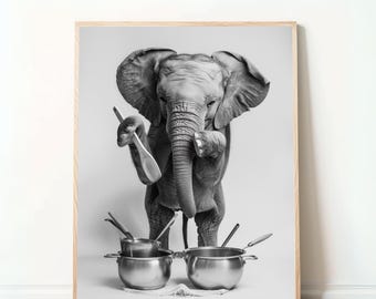 May include: A black and white photograph of a baby elephant holding a wooden spoon and standing in front of two stainless steel pots. The elephant is looking at the camera.
