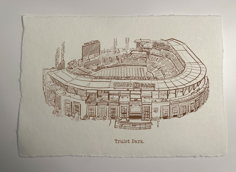 May include: A sepia-toned pen and ink drawing of Truist Park baseball stadium. The detailed illustration shows the stadium's architecture, including the seating, scoreboard, and exterior features. The text "Truist Park" is at the bottom.