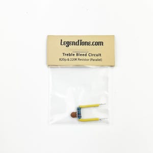 May include: A small, clear plastic bag containing a treble bleed circuit with a brown and blue resistor and yellow wires. The bag has a label that reads "LegendTone.com Treble Bleed Circuit 820p & 220K Resistor (Parallel)"