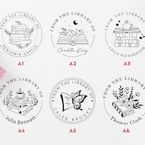 May include: Six black and white illustrations of book-themed rubber stamps. Each stamp features a different design, including a stack of books, an open book with mountains and a crescent moon, a stack of books with a coffee cup, an open book with a butterfly, a stack of books with a coffee cup and leaves, and a stack of books with flowers. Each stamp includes the text "From the Library of" and a name.