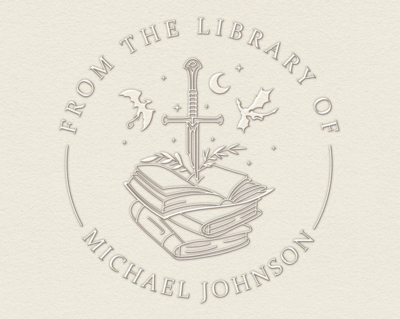 May include: A white circular stamp with the text "From the Library of Michael Johnson" around the edge. A sword is piercing a stack of books with a crescent moon and two bats in the background.