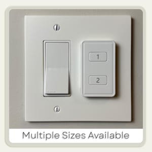 May include: A white electrical wall plate with a toggle light switch and a two-button control panel. The control panel is labeled with the numbers "1" and "2". The text "Multiple Sizes Available" is at the bottom of the image.