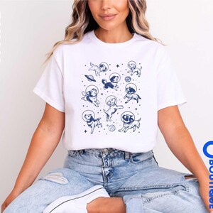 a woman sitting on a stool wearing a white t - shirt