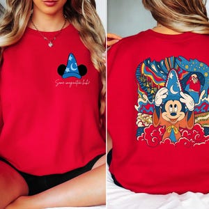 May include: Red sweatshirt with a Mickey Mouse illustration wearing a sorcerer hat. The text "Some imagination left" is printed on the front of the shirt. The back of the shirt features a colorful illustration of Mickey Mouse as a sorcerer.
