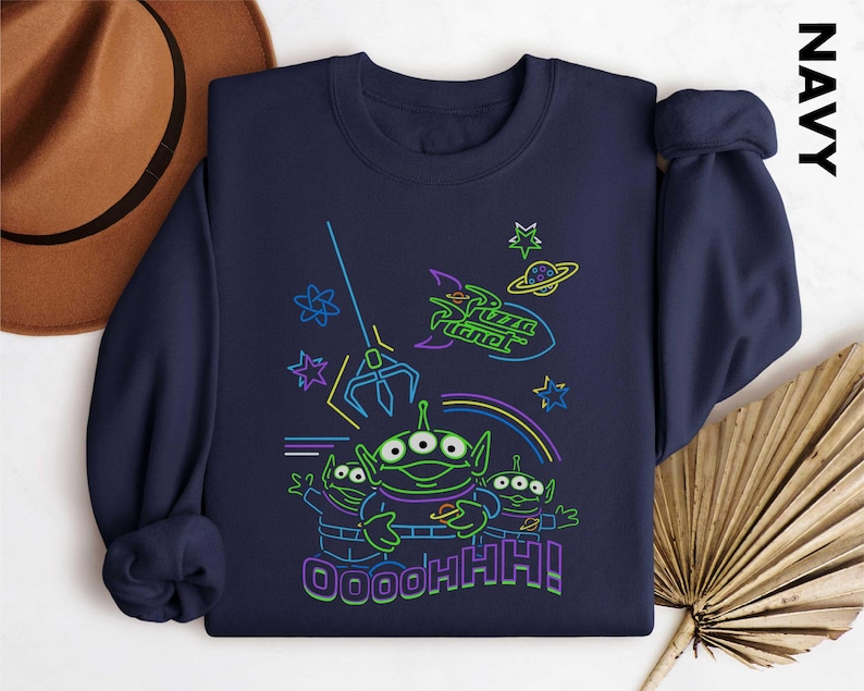 May include: Navy blue sweatshirt with a neon graphic of the Pizza Planet aliens from Toy Story. The design includes the Pizza Planet logo, a claw, stars, and the text "OOOOHHH!".