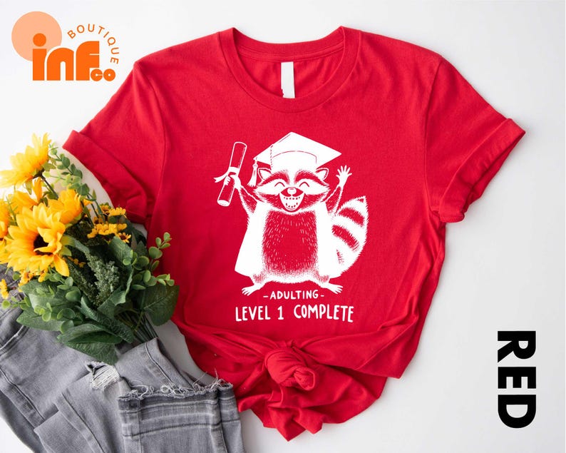 a red shirt with a raccoon on it
