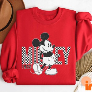 a red shirt with a mickey mouse on it