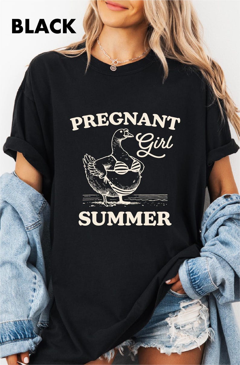 A woman wearing a black t-shirt with a graphic design of a duck and the text "Pregnant Girl Summer" printed on it.