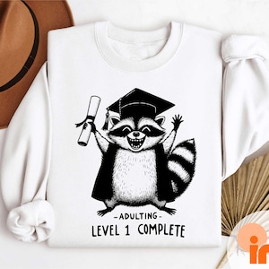 Adulting Level One Complete Raccoon Tee, Funny Raccoon Graduation T-Shirt, Funny Raccoon Grad Sweatshirt, Class of 2026 Sweatshirt image 1
