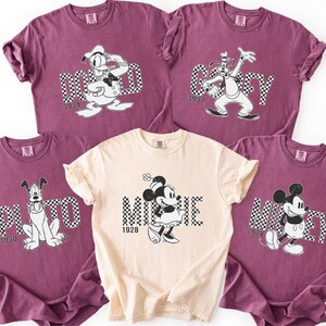 a collection of five Disney Mickey t-shirts, each featuring a different character from the classic animated film series.