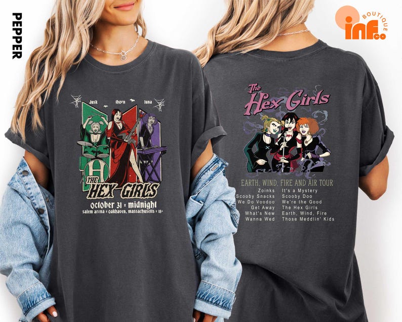 A woman wearing a black t-shirt with a graphic design featuring the band The Hex Girls and their music.