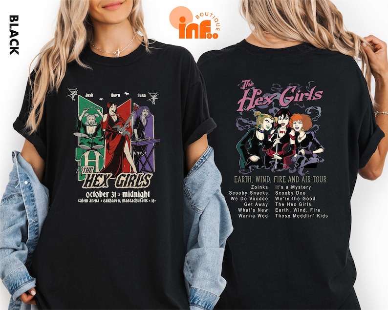 a woman wearing a black t-shirt with a graphic design of a group of people and text related to a concert or event.