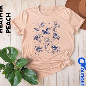 a t - shirt with an image of a bunch of aliens on it
