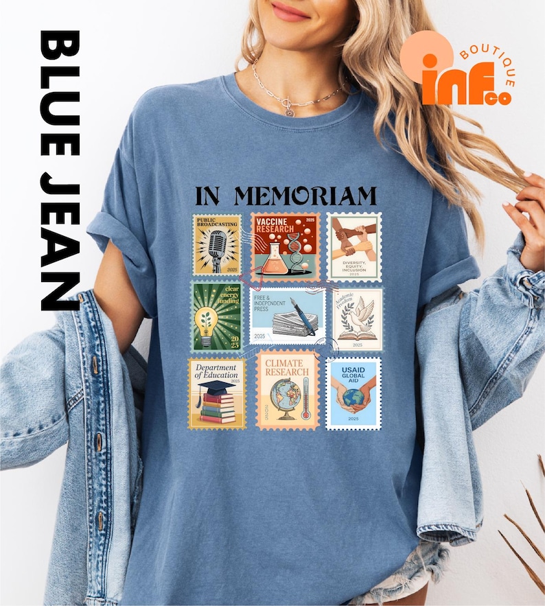 A woman wearing a blue t-shirt with a collage of various postage stamps printed on it, along with a denim jacket.