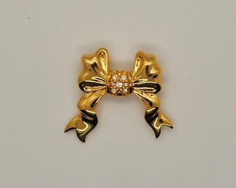 Gouden strikbroche - Joan Rivers - goudkleur met heldere stenen - gesigneerd