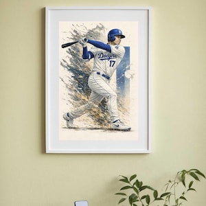 Puede incluir: Una impresión artística enmarcada de un jugador de béisbol con uniforme de los Dodgers, en pleno swing. El jugador lleva un casco azul y una camiseta con el número 17. El fondo presenta salpicaduras de pintura azules y blancas.