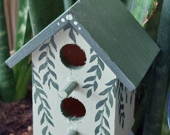 Small decorative painted birdhouse greenleaves