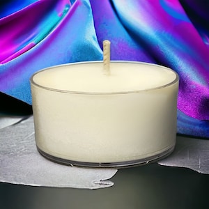 May include: A white unscented votive candle in a clear glass container with a wick.