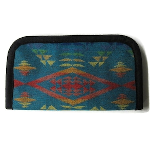 May include: A teal blue wallet with a colorful geometric pattern. The wallet has a black border and is made of a soft, woven fabric.