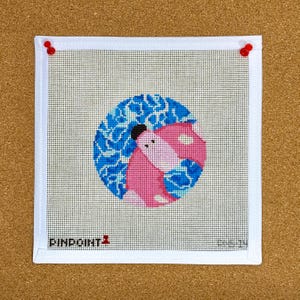 May include: A white canvas with a blue and pink design of two fish swimming in a circle. The canvas is stretched over a wooden frame and has a white border. The text "FINPOINT" is printed in the bottom left corner.