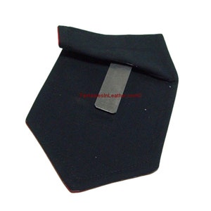 May include: Black leather wallet with a silver money clip. The wallet has a red trim and is shaped like a shield. The text "fantasiesinleather.com" is visible on the wallet.