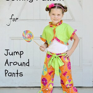 May include: PDF sewing pattern for Jump Around Pants. The pattern features a young person wearing a green and white striped top with a ruffled hem and orange pants with a colorful candy cane design. The pants have a green sash.