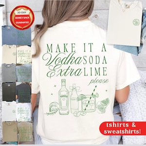 May include: White t-shirt with the text "Make it a Vodka Soda Extra Lime please" in green lettering. The design also includes a drawing of a bottle of vodka, a bottle of soda, and a glass of vodka soda with a lime wedge. The text "tshirts & sweatshirts!" is in the lower right corner.
