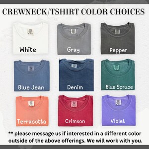 May include: A chart showing 10 different color choices for a crewneck t-shirt. The colors are: White, Gray, Pepper, Blue Jean, Denim, Blue Spruce, Terracotta, Crimson, Violet. The text "** please message us if interested in a different color outside of the above offerings. We will work with you." is at the bottom of the chart.