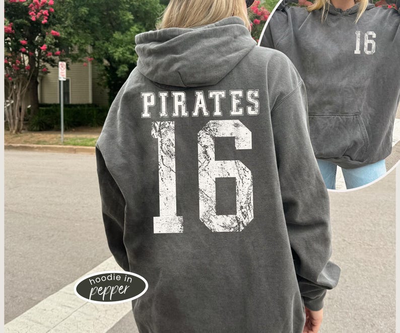May include: A gray hoodie with the word "PIRATES" and the number "16" printed on the back in white. The hoodie has a drawstring hood and a front pocket. The image also shows a smaller image of the same hoodie.