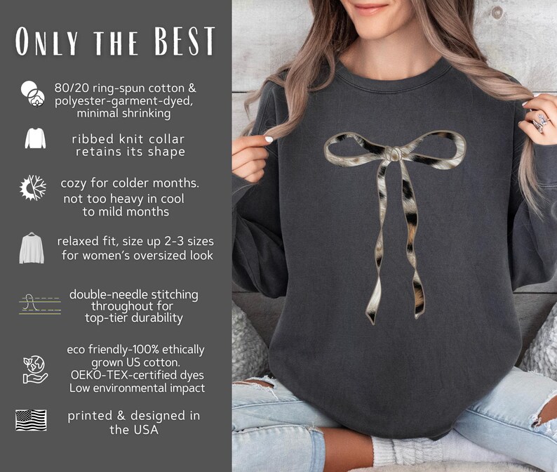May include: A dark gray sweatshirt with a large, black and white animal print bow on the front. The sweatshirt has a relaxed fit and is made from a blend of cotton and polyester. The text "ONLY THE BEST" is printed on the left side of the image.
