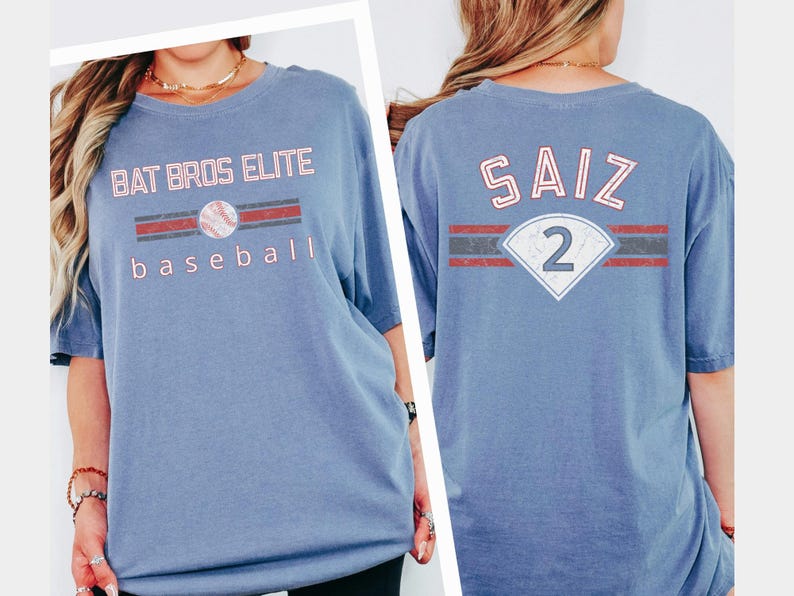May include: A light blue baseball t-shirt with the text "BAT BROS ELITE BASEBALL" on the front and "SAIZ 2" on the back. The design includes a baseball graphic and red and grey stripes.