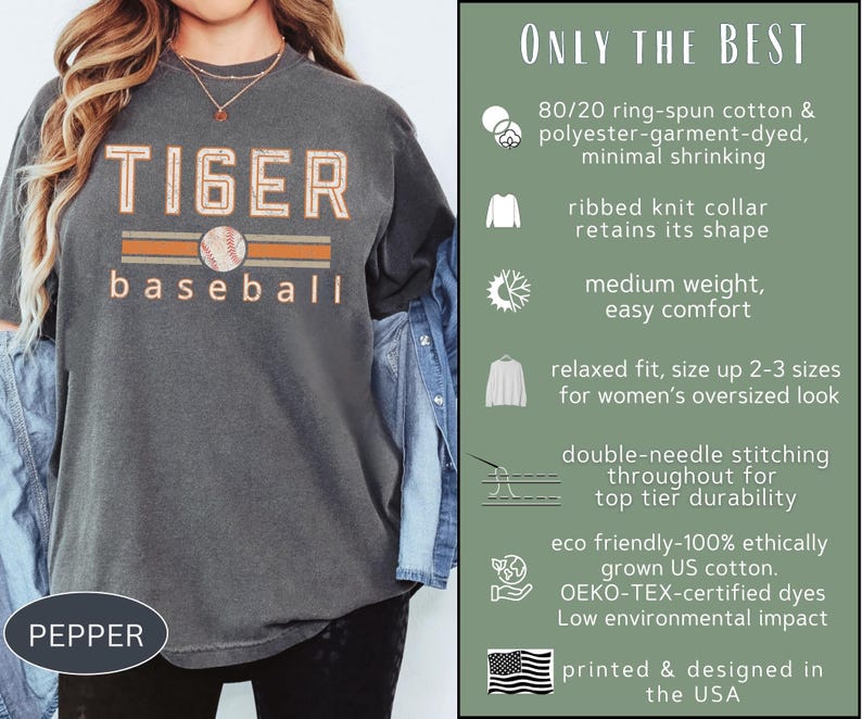 May include: Pepper-colored t-shirt with "TIGER baseball" text in orange and white, featuring a baseball graphic. The shirt is made of ring-spun cotton and polyester, with a relaxed fit and double-needle stitching. Printed and designed in the USA.