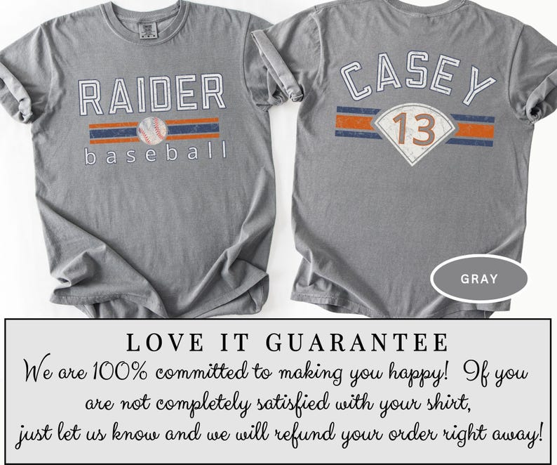 May include: Gray baseball t-shirt with "RAIDER baseball" printed on the front, featuring a baseball graphic. The back of the shirt displays "CASEY 13". The shirt has a crew neck and short sleeves. The word "GRAY" is printed on the bottom right.