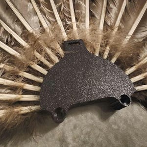 May include: A handmade, wooden cutting board with a natural finish. The board features a live edge on one side and a rectangular shape. It is approximately 18 inches long, 12 inches wide, and 1 inch thick.