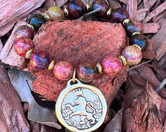 Lion and Crown Charm Bracelet with Mauve Gemstones and Antiqued Gold Plating