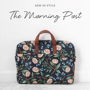 May include: A soft-lined, padded laptop bag with a floral pattern in navy, peach, and green. The bag has a brown handle and fits a 17-inch laptop. Text on the bag reads "The Morning Post" and "Sallie Tomato".