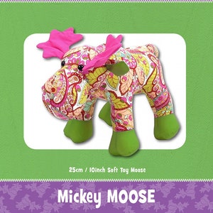 May include: A pink and green moose soft toy with a paisley pattern. The toy is 25cm tall and is called "Mickey Moose".