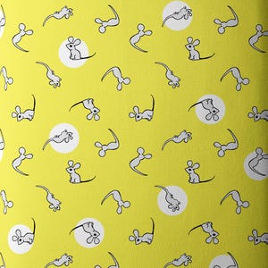 May include: A roll of yellow fabric with a repeating pattern of white mice and white circles. The fabric has the text "CLOUD9" printed on the top edge.