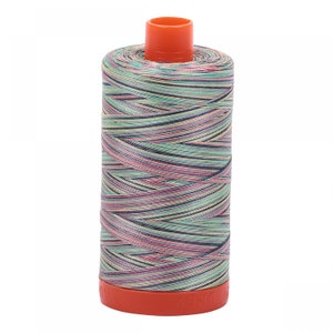 May include: A spool of multi-colored thread with a bright orange plastic bobbin. The thread is a mix of pink, green, blue, and yellow.