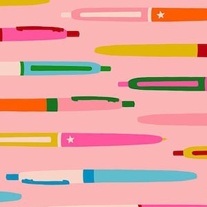 May include: A pink fabric featuring a pattern of colorful pens in various shades. The pens are in orange, yellow, pink, blue, and green, with white accents and star details. The text "RUBY STAR SOCIETY" is at the bottom.