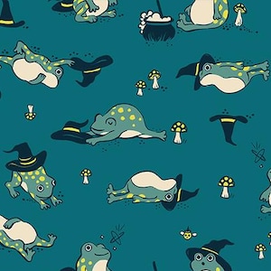 May include: Teal fabric with a repeating pattern of cartoon frogs in witch hats and yellow spots. The design includes mushrooms and witch hats. The text "RUBY STAR SOCIETY" is at the bottom of the image.