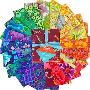 May include: A set of 18 colorful fabric squares with various patterns, including floral, geometric, and abstract designs. The squares are arranged in a fan shape and are tied together with a blue ribbon. The label reads "Kaffie Fassett Collective for"