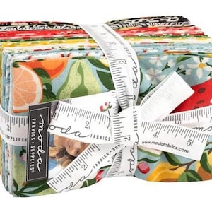 May include: A stack of 12 Moda Fabrics fat quarters featuring a variety of colourful floral and fruit prints. The fabric bundle is tied with a white ribbon and a measuring tape. The label reads "Moda Fabrics & Supplies".