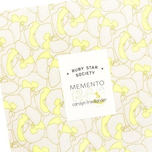 May include: Square fabric piece with a repeating pattern of yellow and cream-colored floral shapes. A white label in the center reads "RUBY STAR SOCIETY MEMENTO" with the designer's name. The fabric is likely for quilting or crafting.