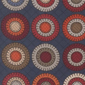 May include: A fabric with a repeating pattern of colorful circles. The circles feature concentric rings in shades of red, orange, brown, and beige, set against a dark blue background. The fabric has a textured appearance.