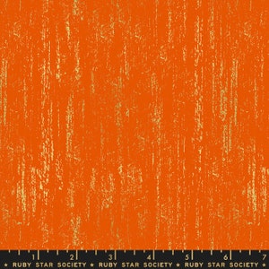 May include: Orange fabric with a gold metallic textured pattern. The fabric has a subtle vertical stripe pattern. The fabric is from Ruby Star Society.