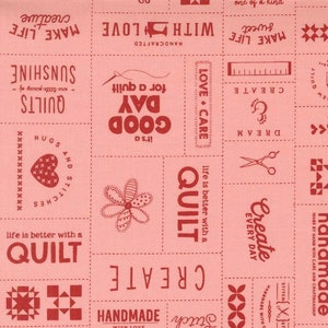 May include: Pink fabric with red text and designs. The text includes "Create", "Good Day", "Love & Care", "Handmade with Love", "Life is better with a Quilt", "Dream", "Stitch", and more.