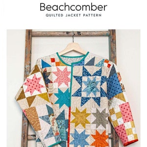 May include: A colorful, quilted jacket pattern titled "Beachcomber" by Laundry Basket Quilts. The jacket features a star pattern in various colors, including pink, blue, and orange. The jacket is displayed on a wooden hanger against a rustic ladder.