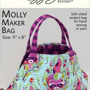 May include: A purple and pink fabric tote bag with a raccoon print. The bag is 11 inches by 8 inches and has a simple tie closure. It is a soft-sided project bag for hand sewing or yarn.