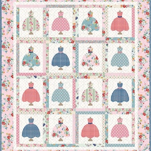 May include: A patchwork quilt featuring a repeating pattern of dresses on dress forms. The dresses are in various colors and patterns, including polka dots, gingham, and floral prints. The quilt has a pink floral border.